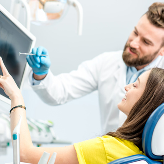 Dentist and patient reviewing X-ray together