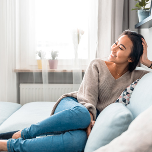 Woman relaxing peacefully at home on her sofa